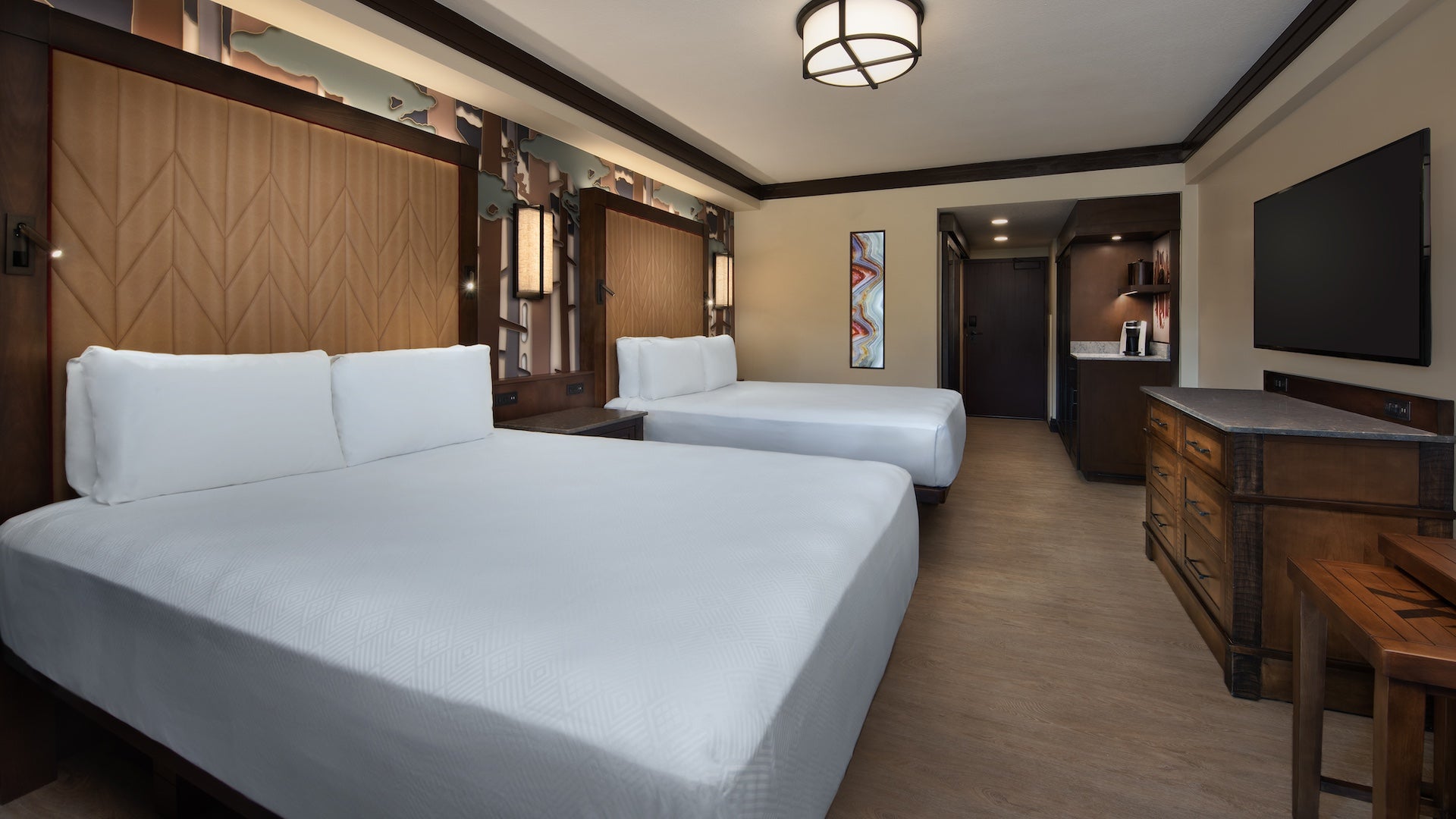 Interior room of Wilderness lodge, two beds and a dresser in a rustic setting
